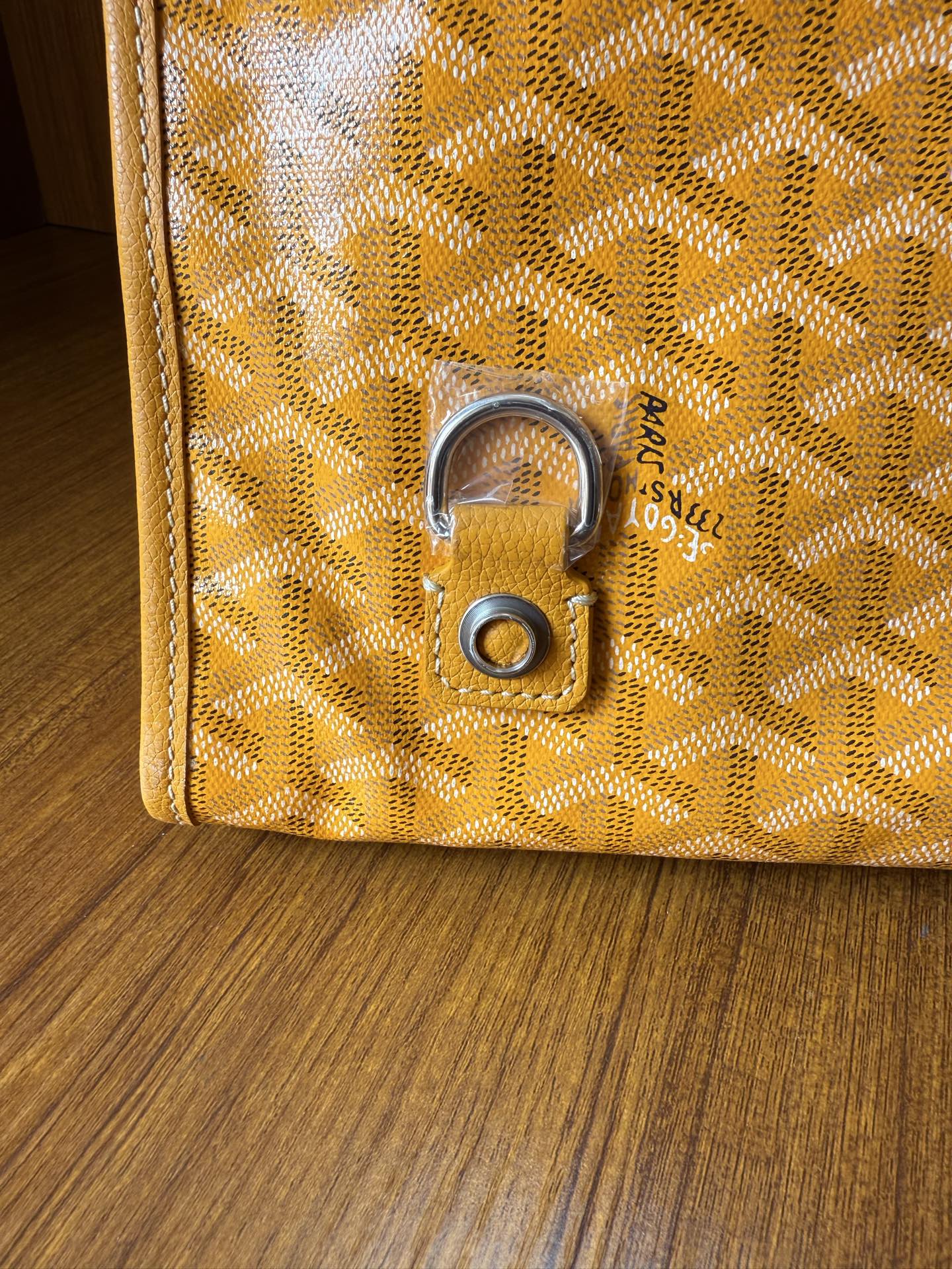 Yellow patterned tote bag with metal lock hardware and textured motif