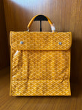 Yellow patterned tote bag with flap, top handle, and metal snap buttons