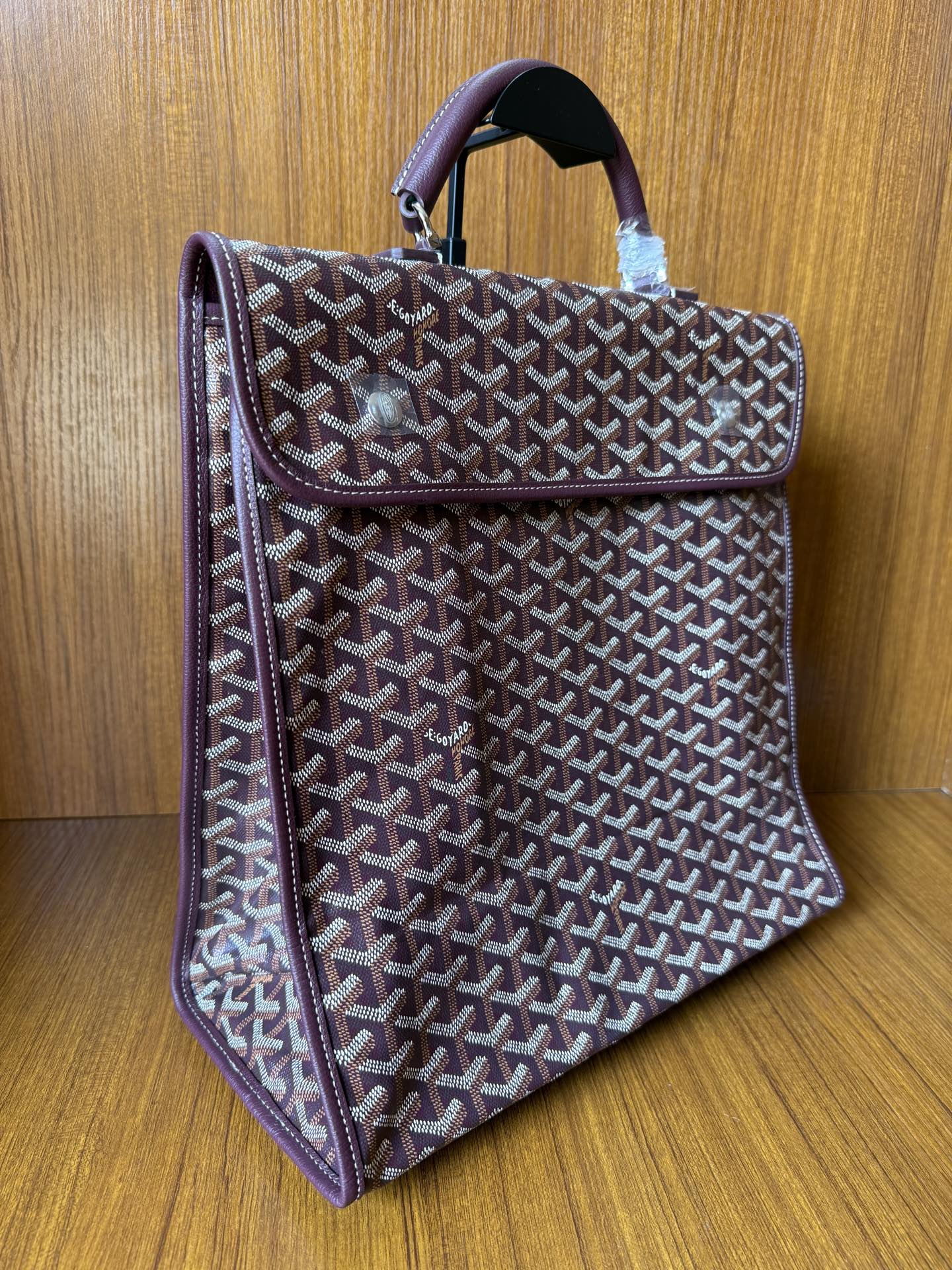 Goyard monogram tote bag with structured side profile and top handle, dark leather trim