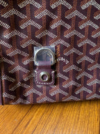 Goyard monogram fabric bag with square metal logo hardware and stitched leather edge