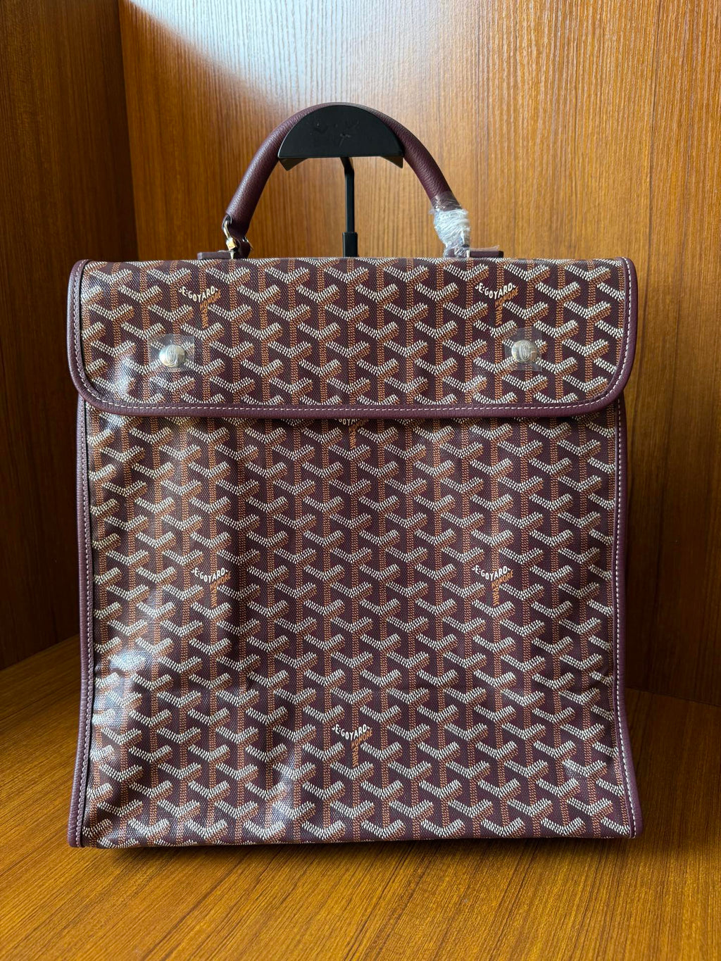 Goyard patterned tote bag with top handle and dark leather trim, front flap style
