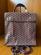 Goyard patterned tote bag with top handle and two leather straps beneath, front view