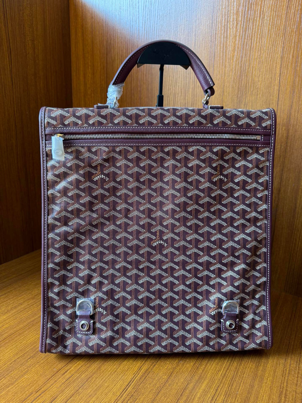 Goyard monogram tote bag with top handle, flap closure, and two front snap tabs