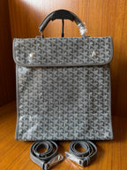 Gray patterned handbag with matching strap set, front flap, and top handles