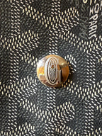 Metal turn-lock on dark gray patterned handbag flap
