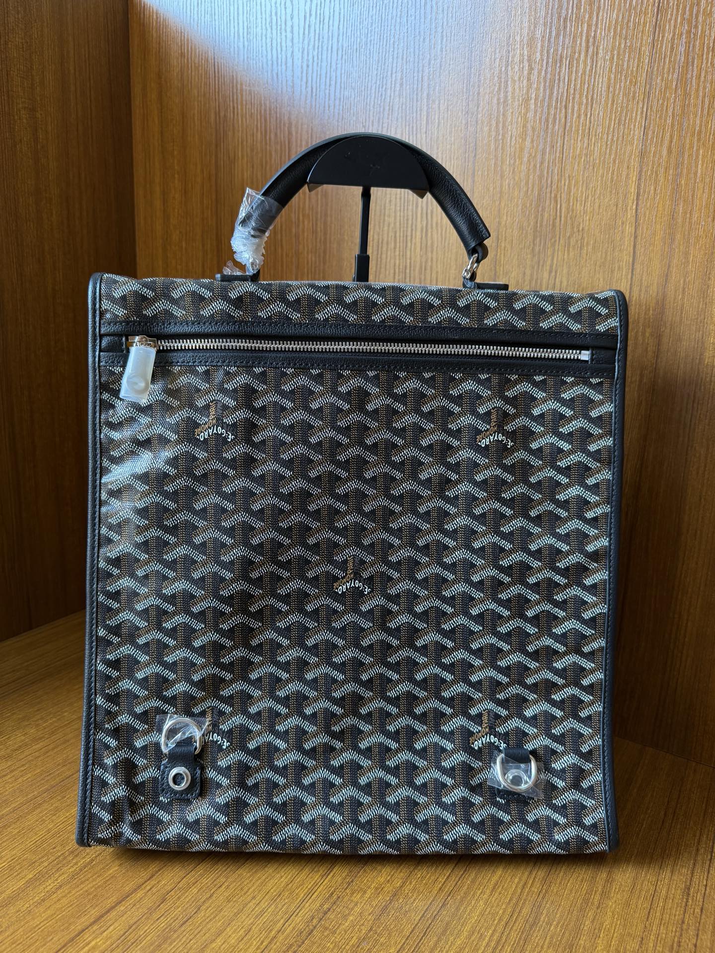 Goyardine patterned bag with top handle, rear view and snap details, dark blue-gray.