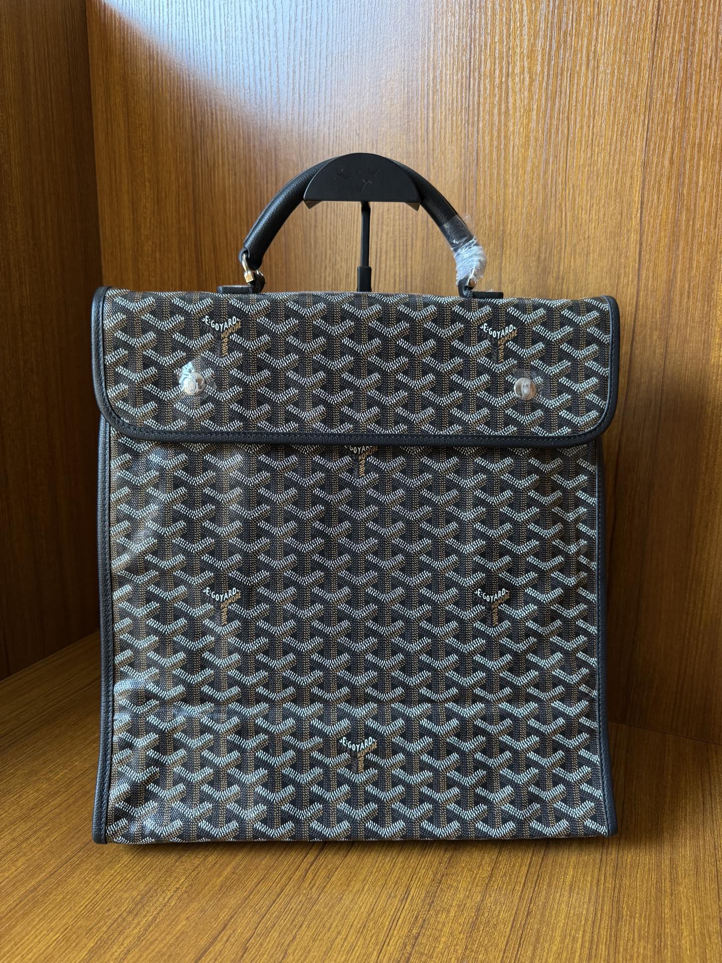 Goyardine patterned bag with fold-over flap and top handles, dark blue-gray.