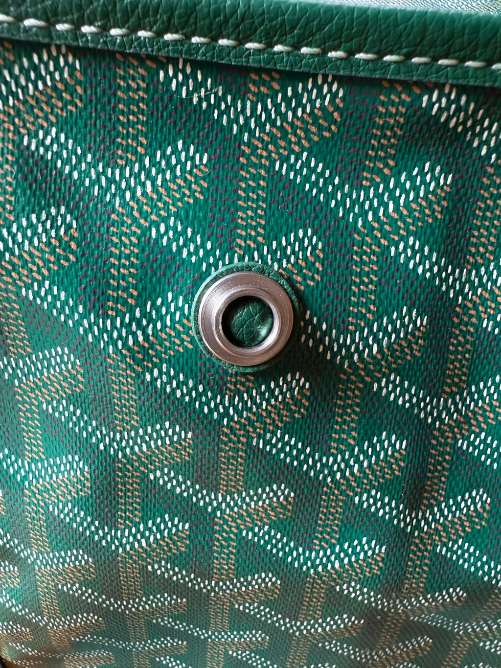 Teal patterned bag side with round eyelet for strap attachment