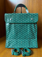 Teal patterned tote bag with flap, top handle, and included crossbody strap