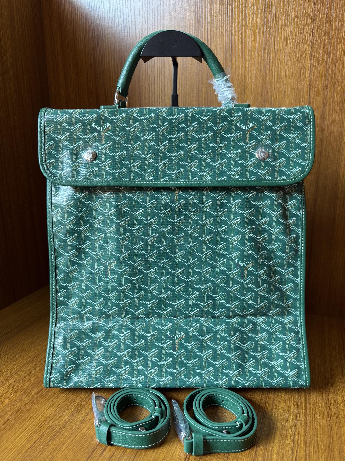 Teal patterned tote bag with flap, top handle, and included crossbody strap