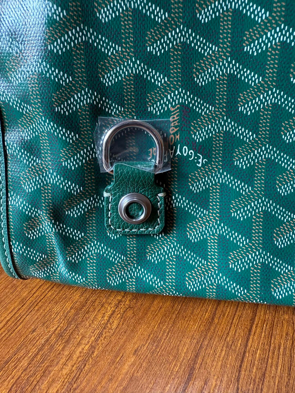 Teal patterned bag lock with silver-tone clasp and circular keeper