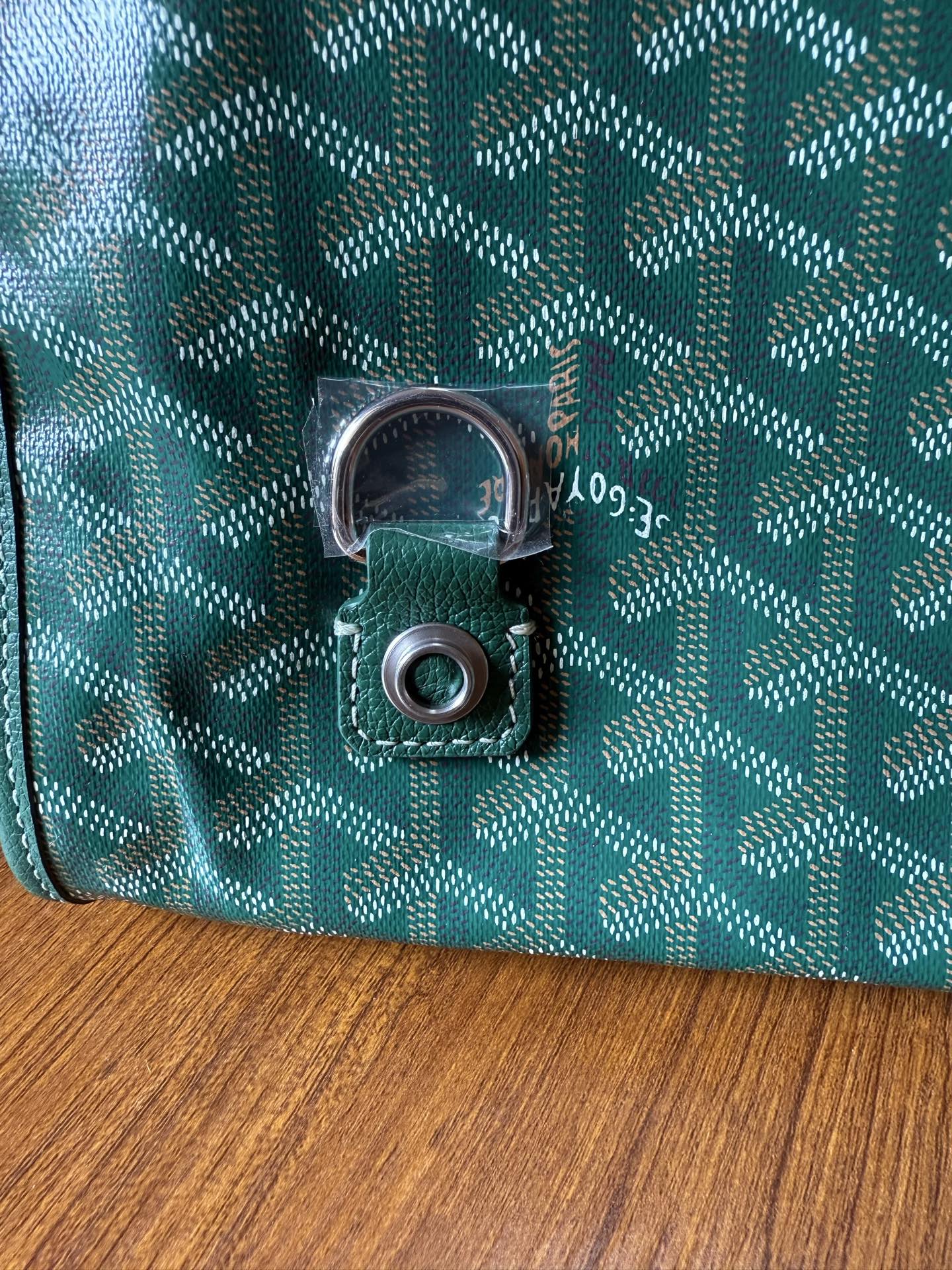 Teal patterned bag lock with silver-tone clasp and circular keeper