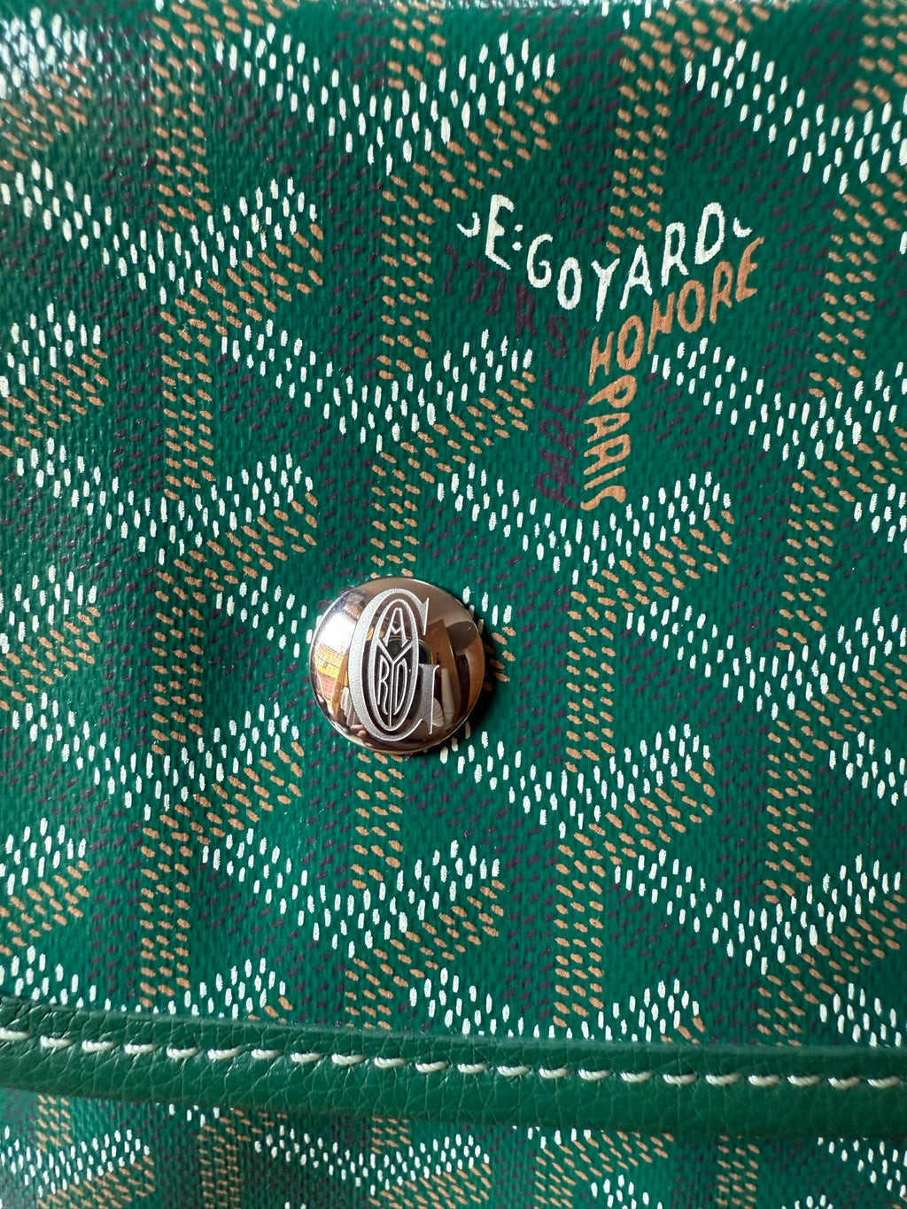 Goyard logo on teal patterned flap with silver-tone snap button