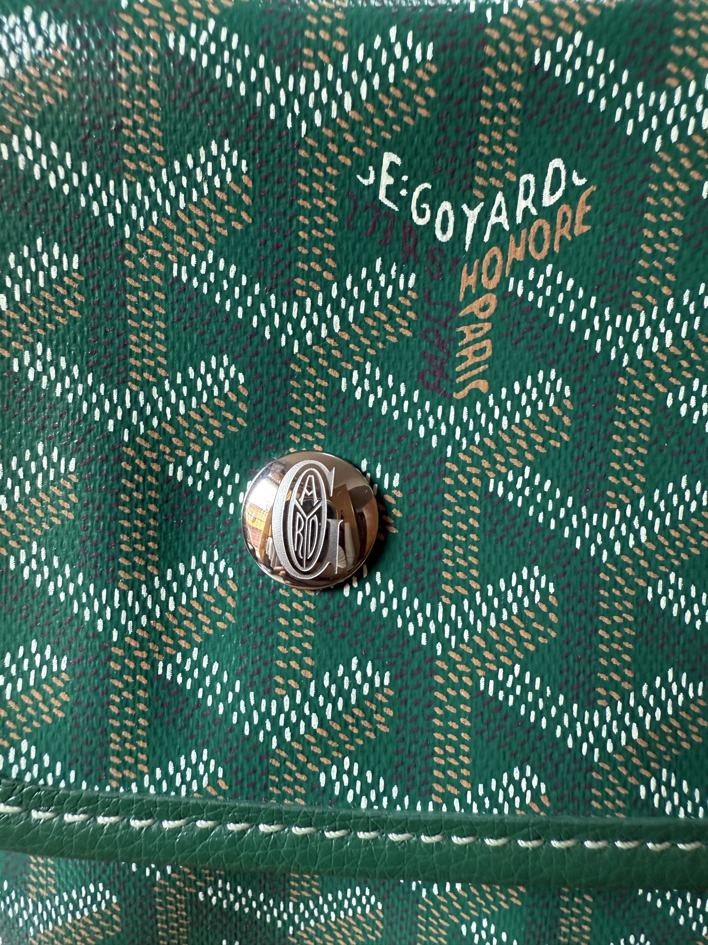 Goyard logo on teal patterned flap with silver-tone snap button