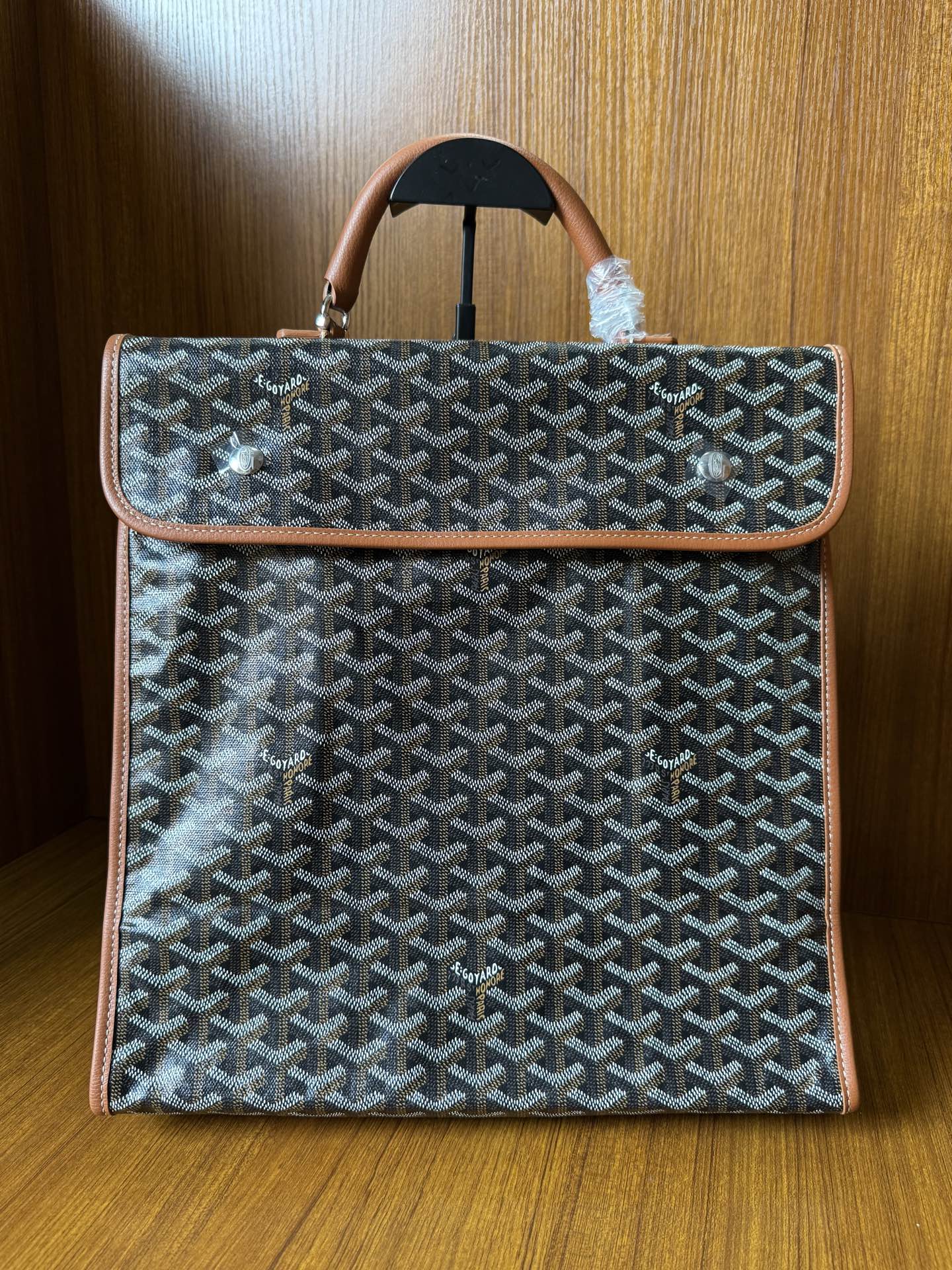 Designer tote bag with Goyard-style pattern, tan leather trim, top handle and flap closure