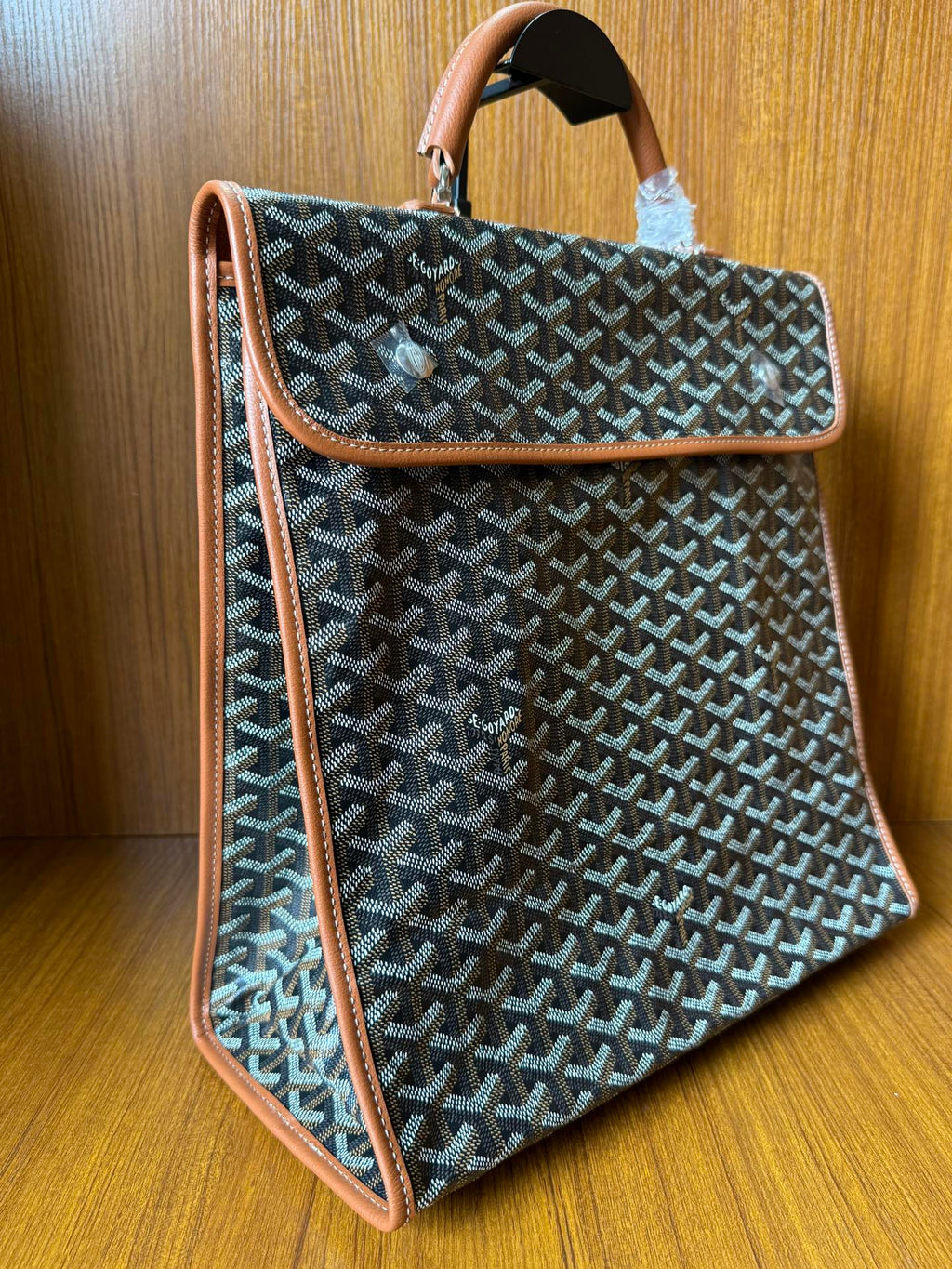 Designer tote bag with Goyard-style pattern, tan leather trim and side strap detail