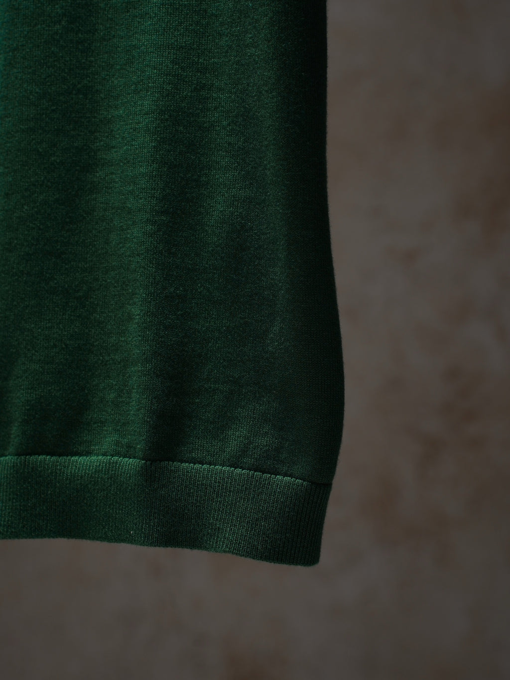Green Dior knit top hem and ribbed cuff detail