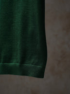 Green Dior knit top hem and ribbed cuff detail