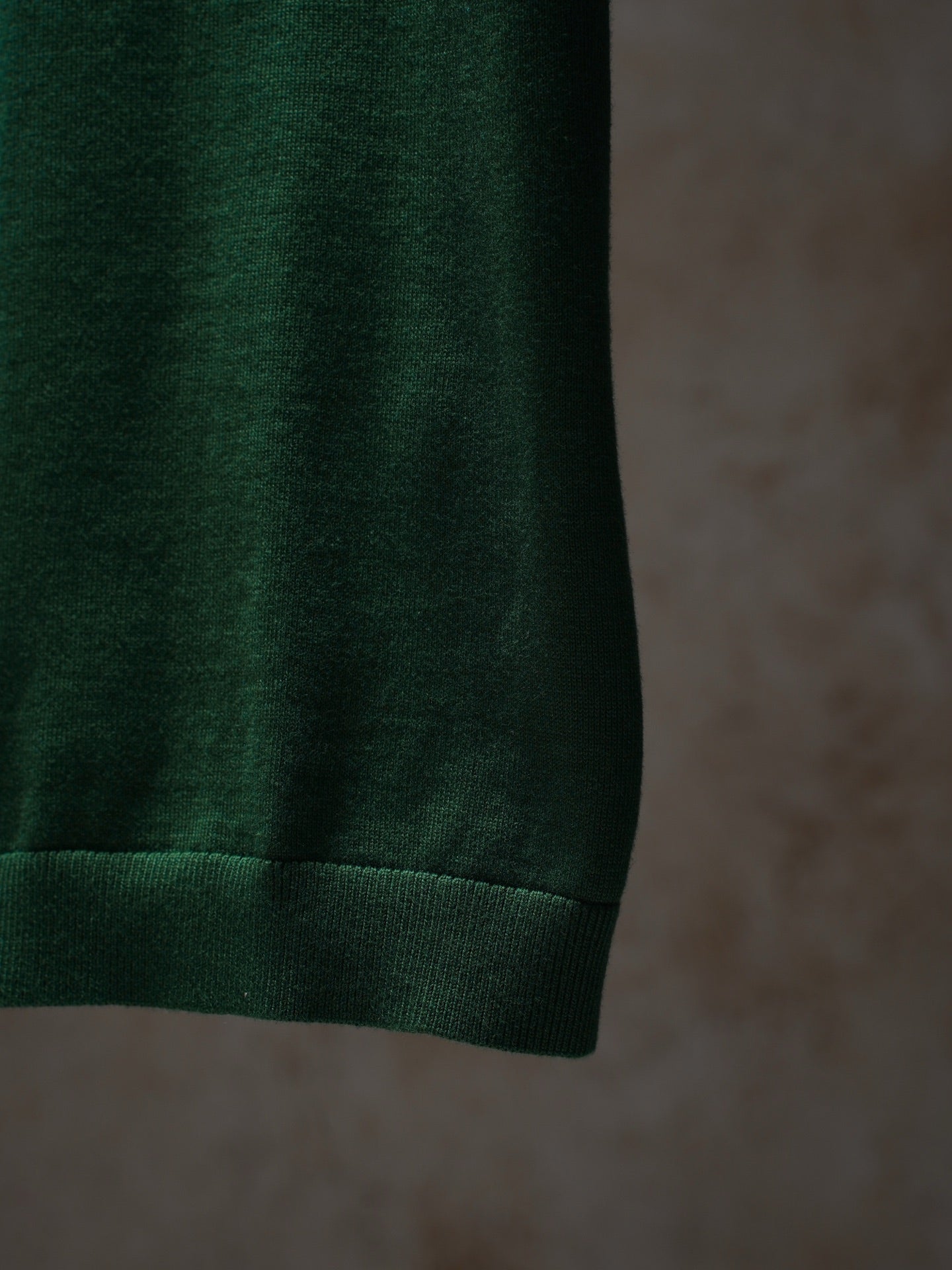 Green Dior knit top hem and ribbed cuff detail