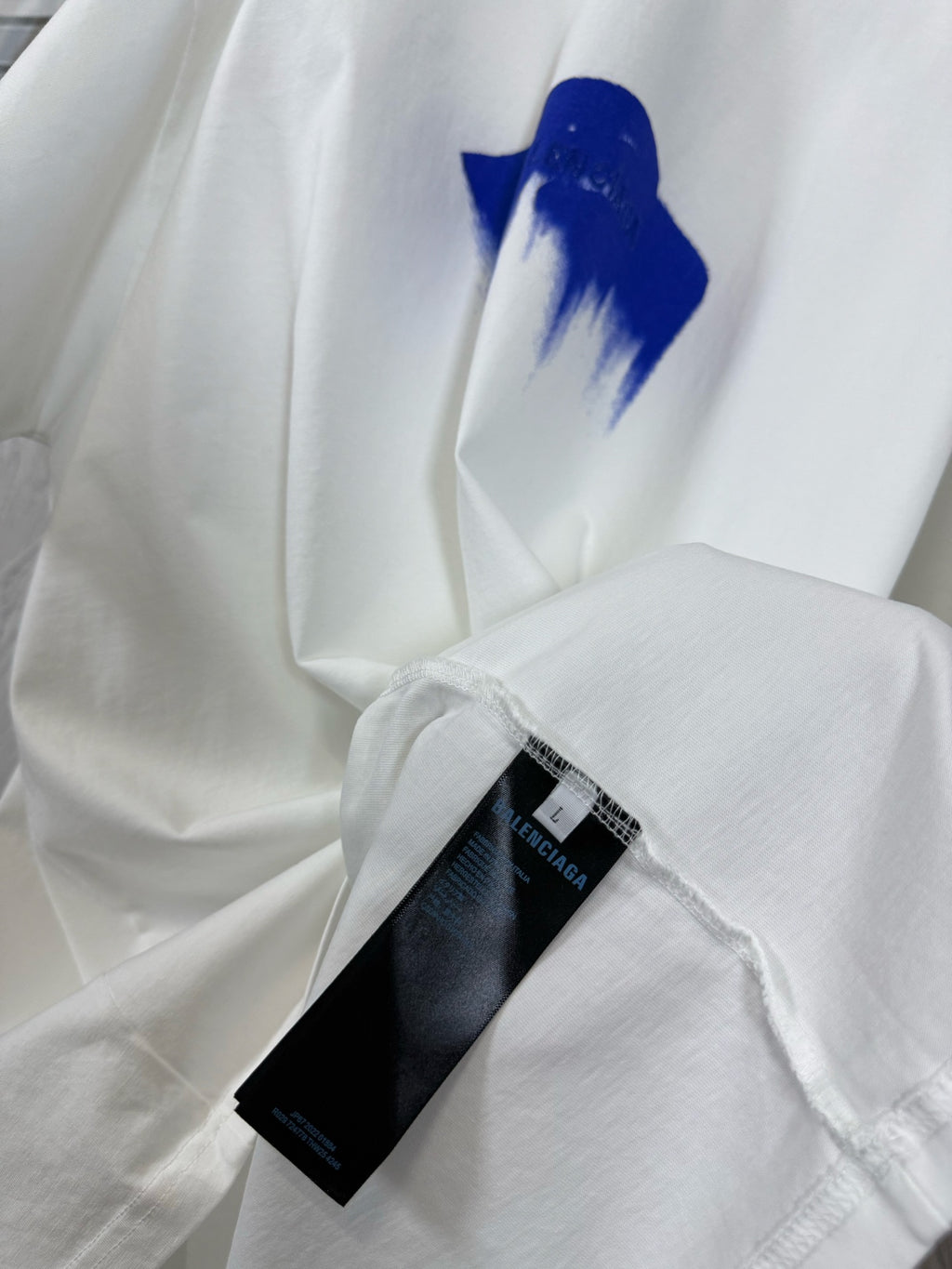 White T-shirt with blue graphic and inner care label detail