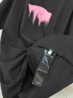 Balenciaga black T-shirt with care tags and pink heart graphic detail