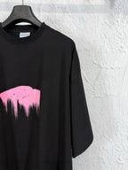 Balenciaga black T-shirt with partial pink heart graphic, close-up