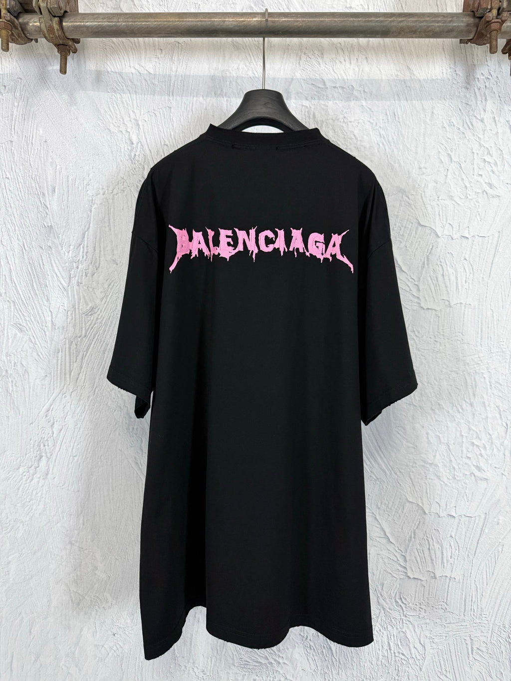 Black short-sleeve T-shirt with large pink Balenciaga logo on the back