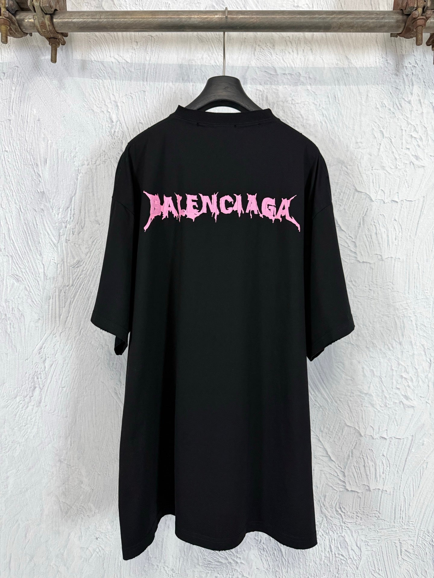 Black short-sleeve T-shirt with large pink Balenciaga logo on the back