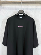 Black crew-neck short-sleeve T-shirt with small pink Balenciaga logo on the chest