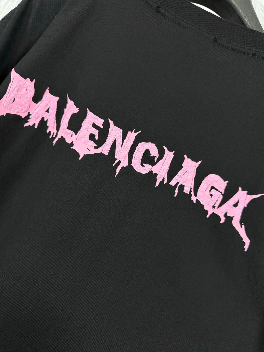 Black T-shirt back logo detail in pink lettering