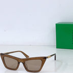 Sunglasses with brown cat-eye frame and light tan lenses, gold-tone hinges