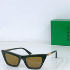 Sunglasses with dark green cat-eye frame and yellow lenses, gold-tone hinges