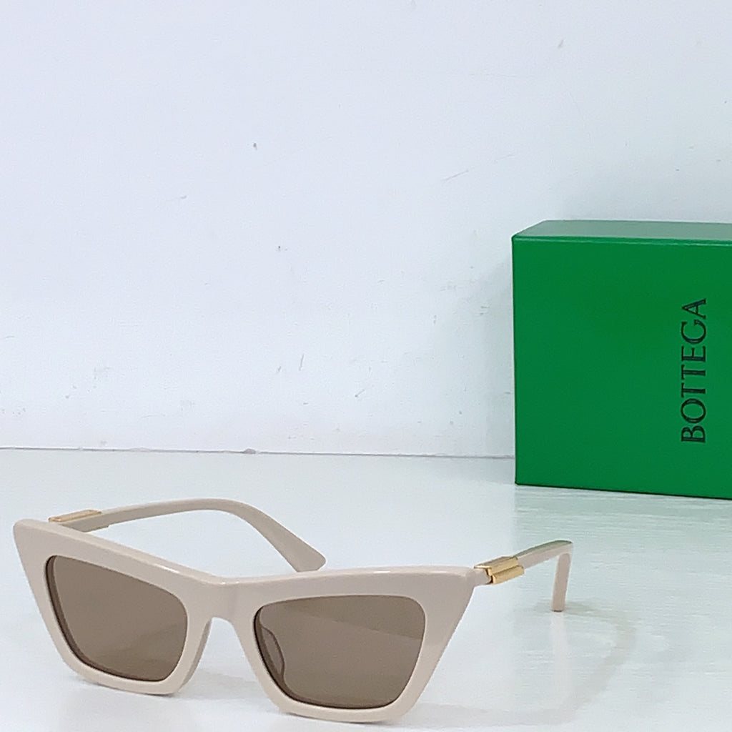 Sunglasses with cream cat-eye frame and tan lenses, gold-tone hinges