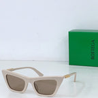 Sunglasses with cream cat-eye frame and tan lenses, gold-tone hinges