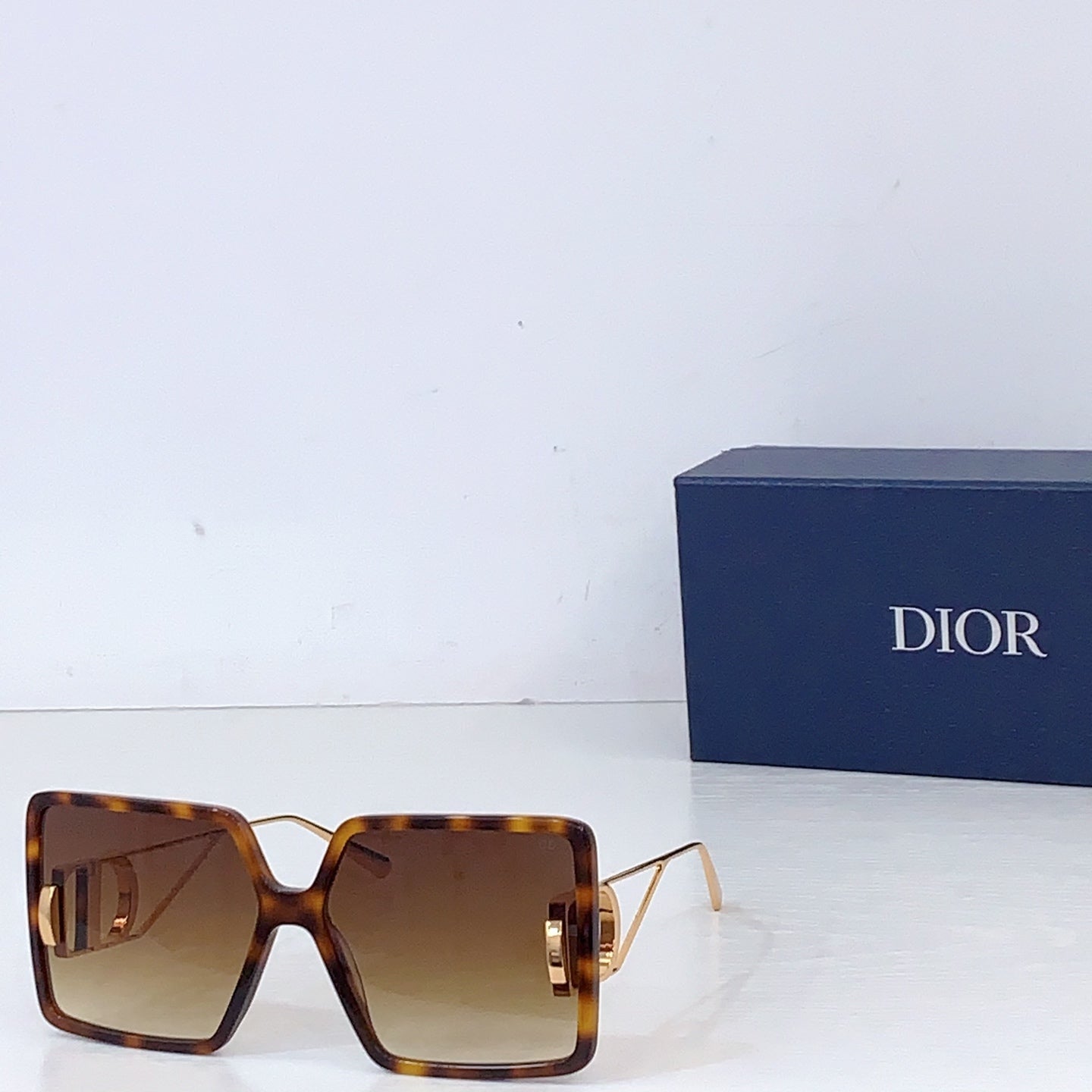Dior sunglasses with tortoiseshell oversized square frames and amber gradient lenses