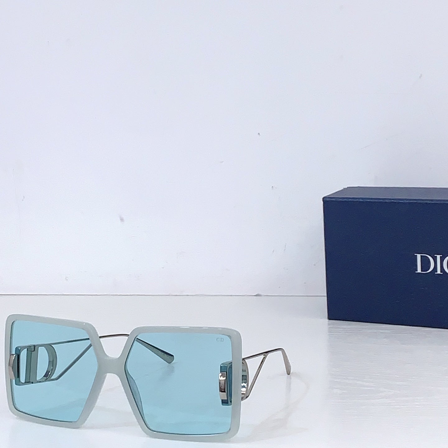 Dior sunglasses with light blue oversized square frames and light blue gradient lenses