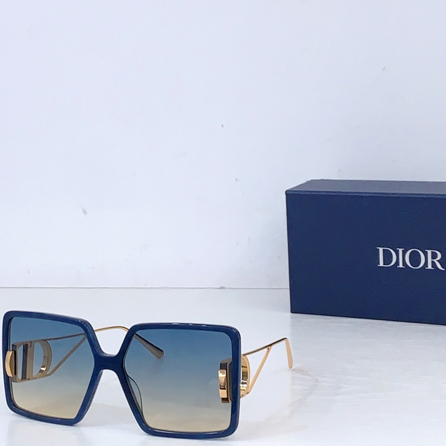 Dior sunglasses with blue oversized square frames and blue gradient lenses
