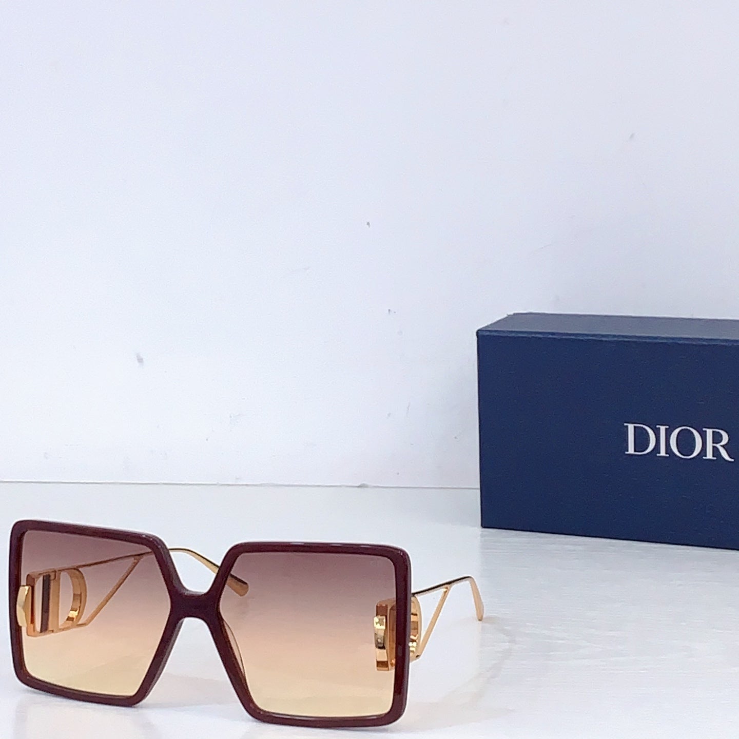 Dior sunglasses with burgundy oversized square frames and brown gradient lenses