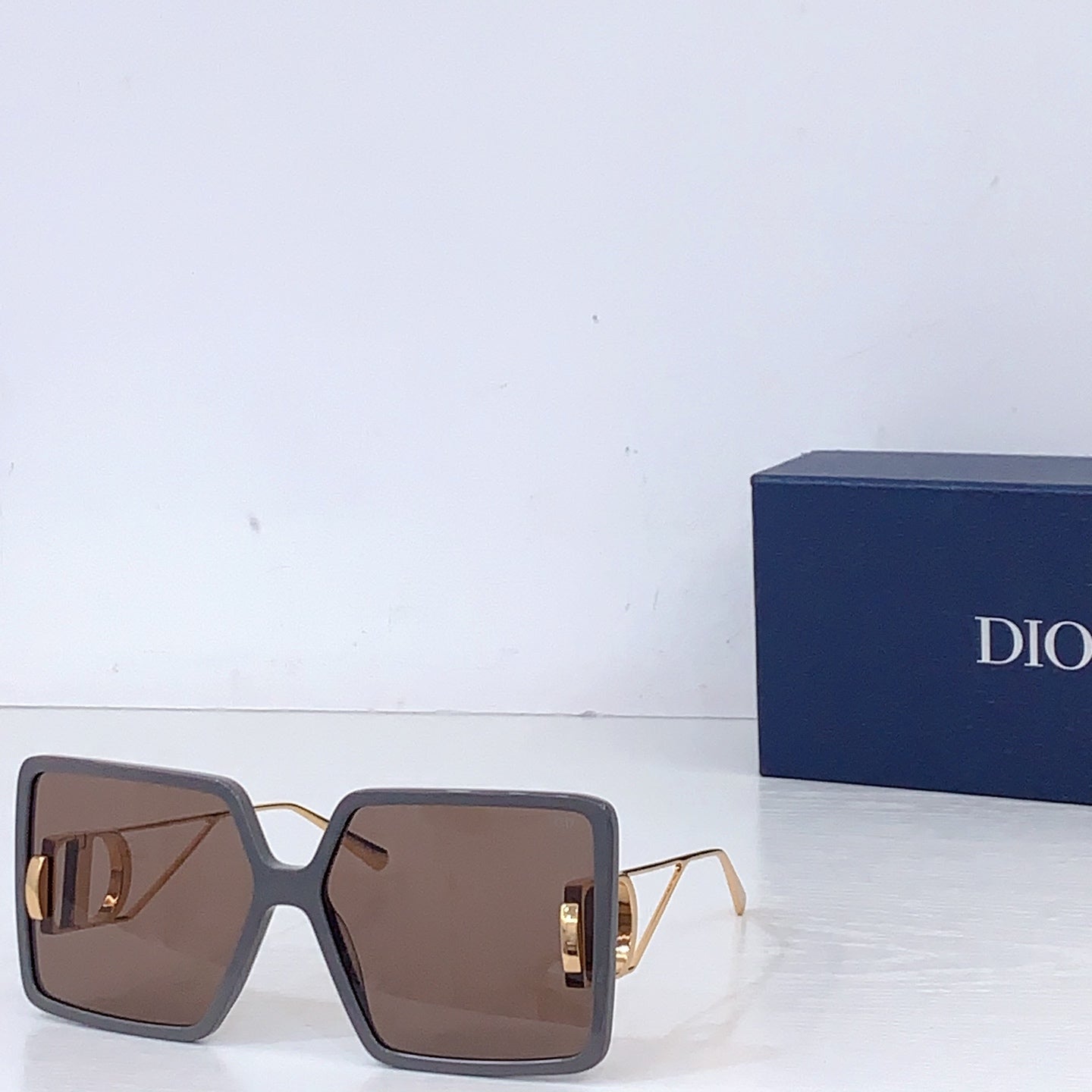 Dior sunglasses with dark brown oversized square frames and brown gradient lenses