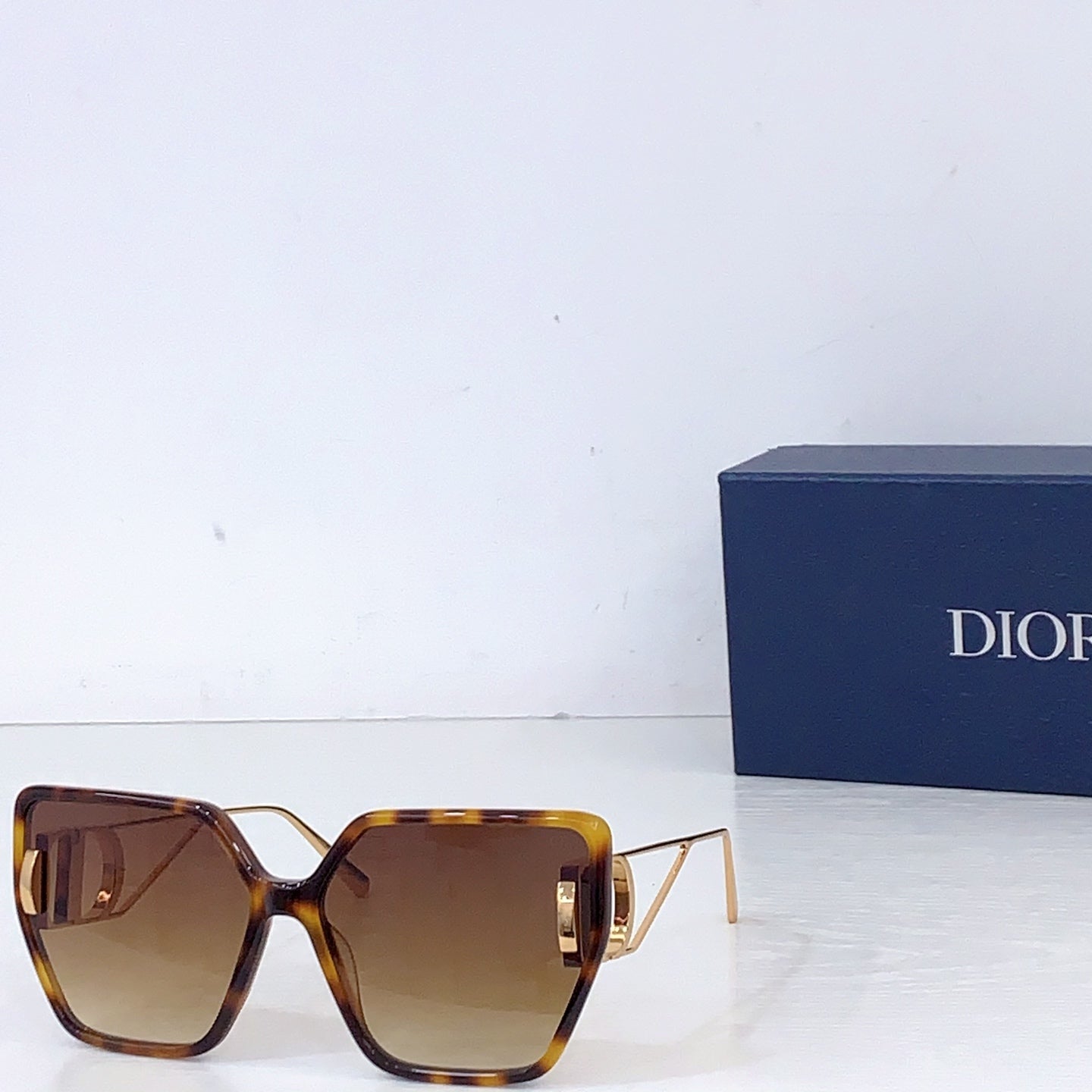 Dior square sunglasses with tortoise frames and amber gradient lenses