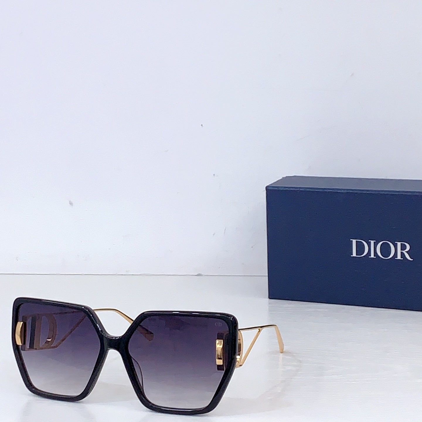 Dior square sunglasses with dark frames and dark tinted lenses