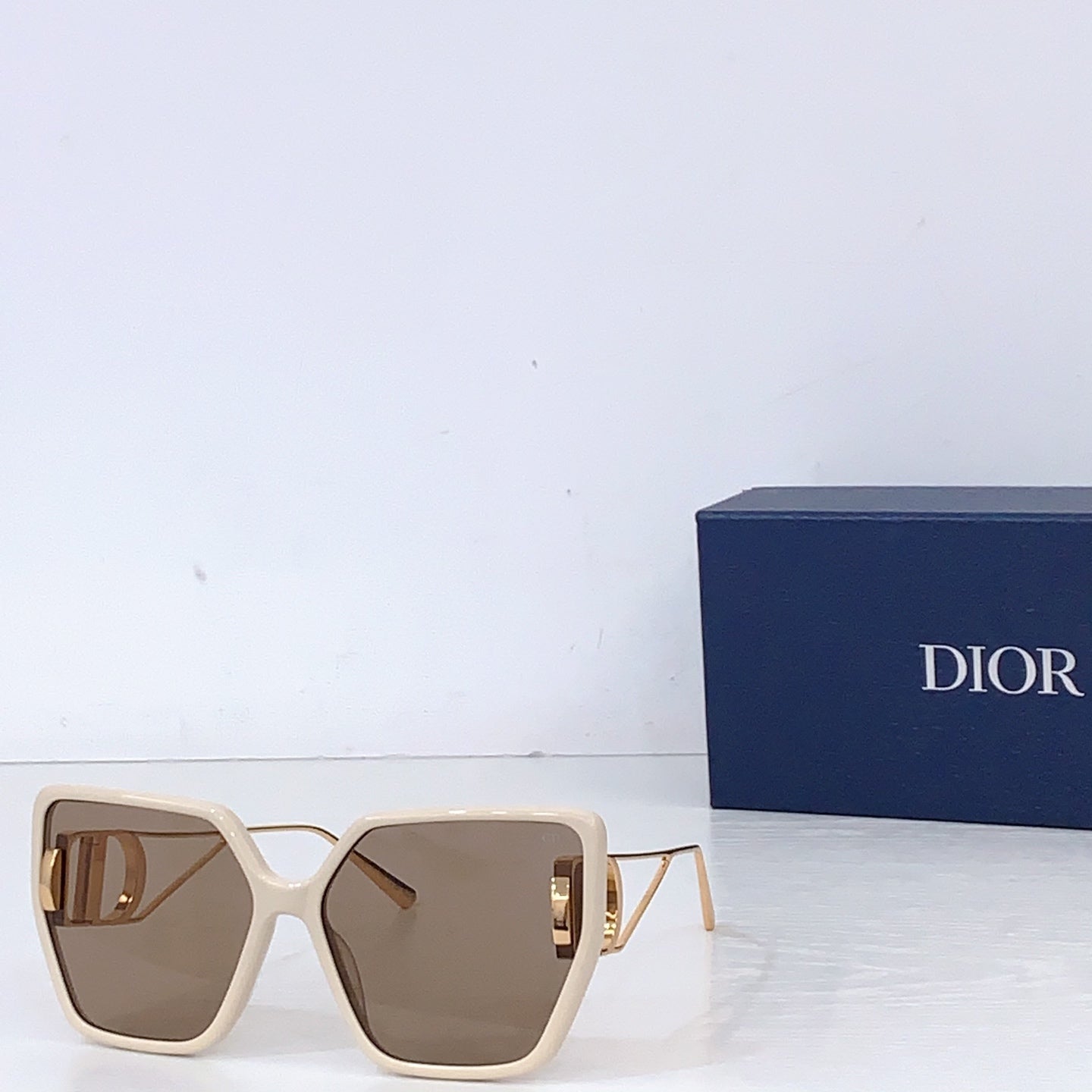 Dior square sunglasses with light cream frames and taupe tinted lenses