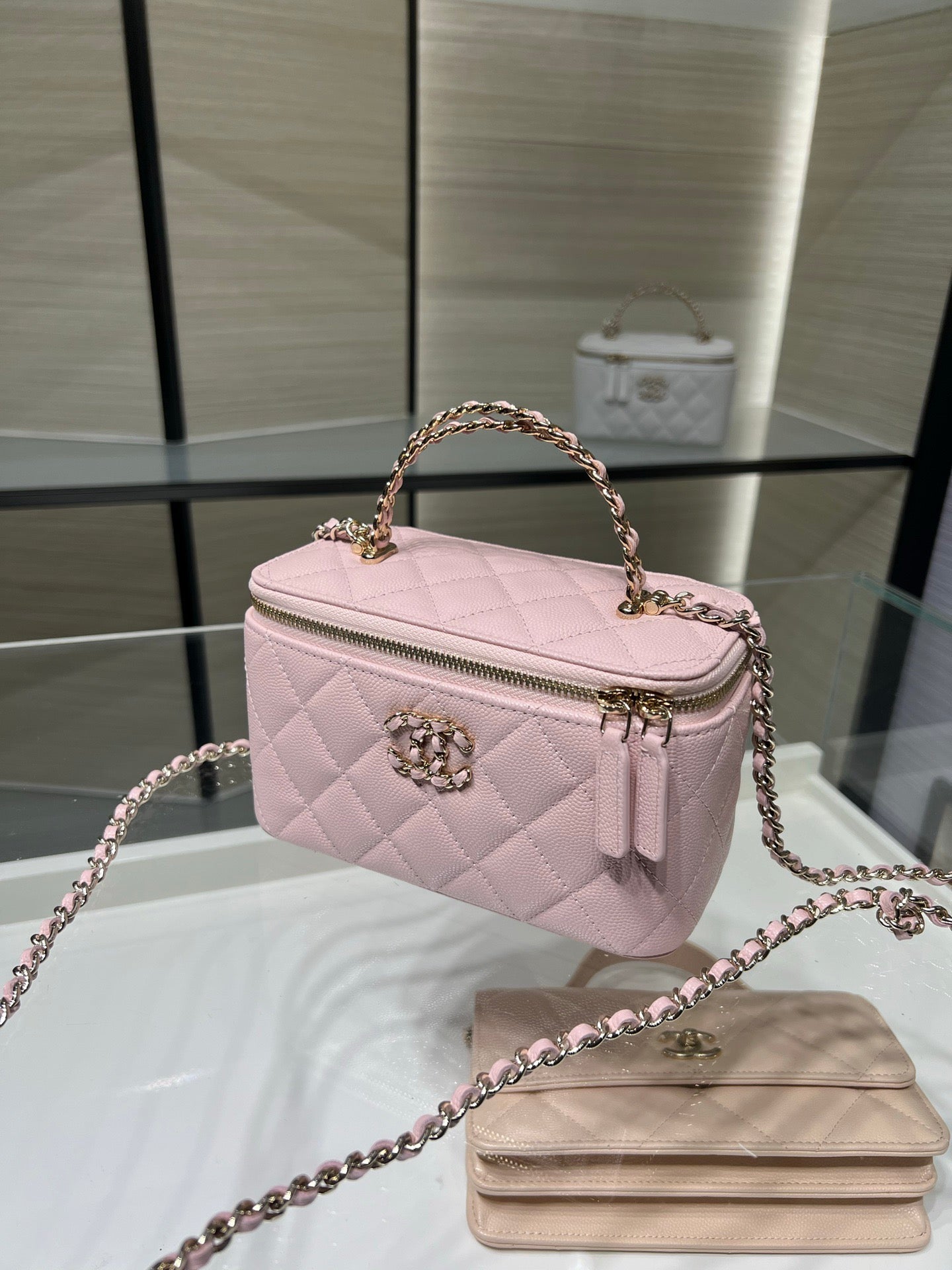 Chanel quilted mini bag in light pink with top handle and chain strap