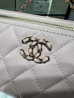 Chanel quilted bag close-up in white with metal CC emblem on front