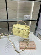 Chanel crossbody bag in pale yellow with gold chain strap, front flap, and top handle
