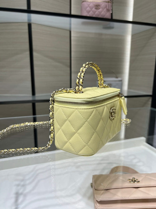 Chanel small quilted bag in pale yellow with top handle and gold chain strap