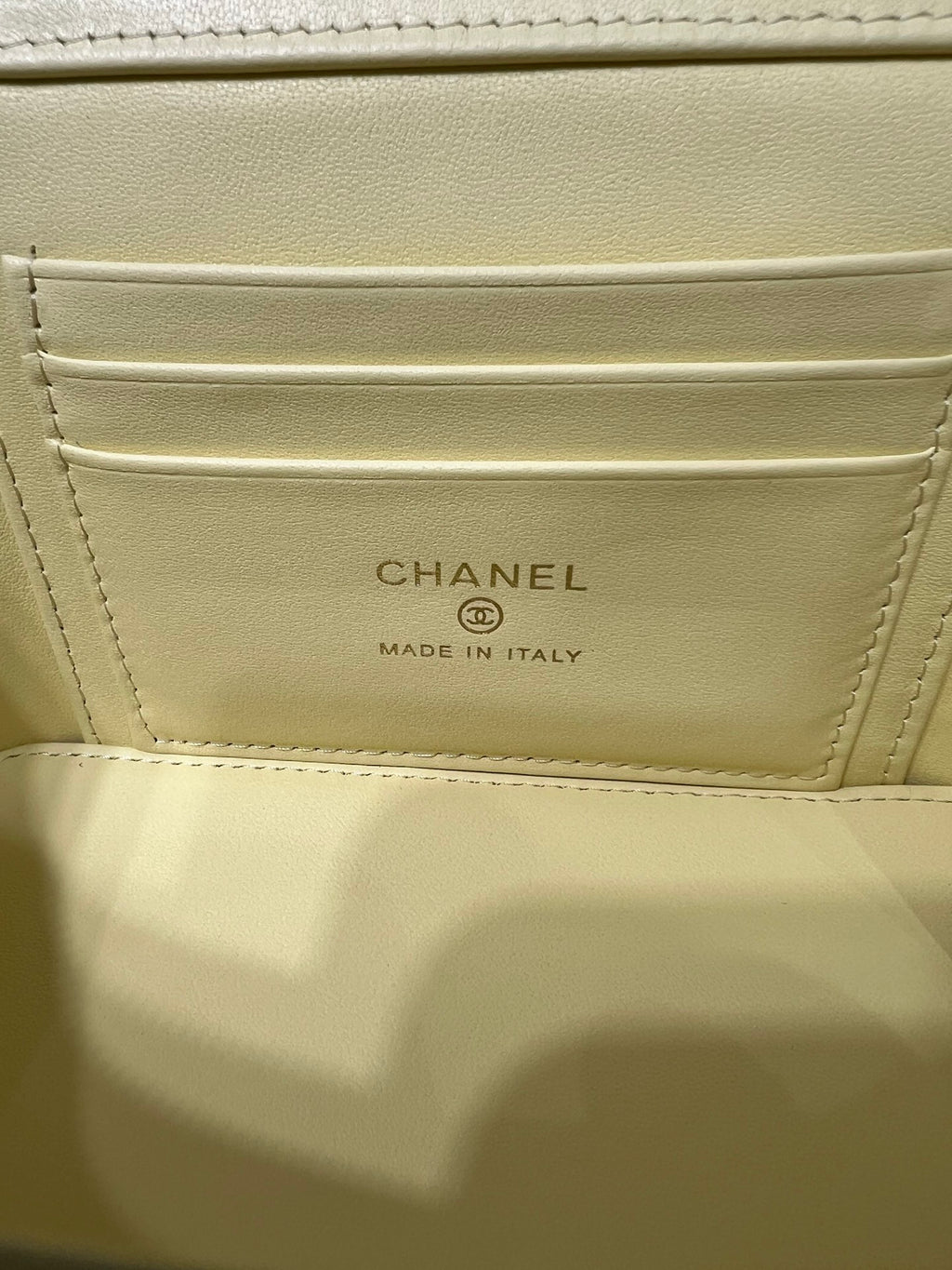 Chanel interior pocket label: CHANEL and MADE IN ITALY on pale yellow lining