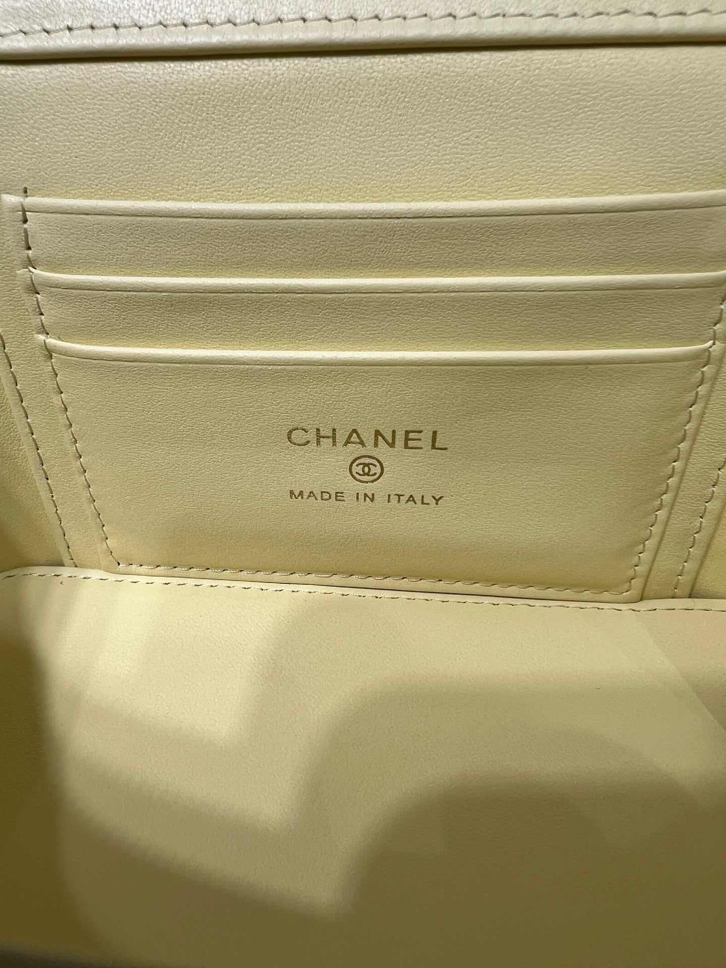 Chanel interior pocket label: CHANEL and MADE IN ITALY on pale yellow lining