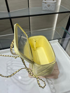 Chanel bag interior view with pale yellow lining and clasp hardware on open flap