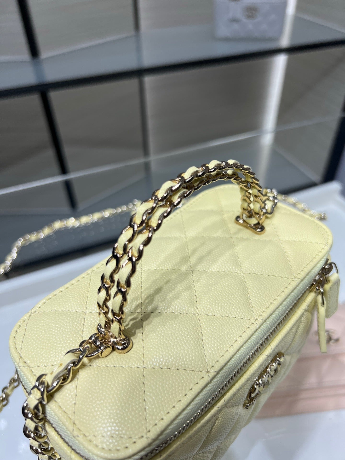 Chanel small quilted shoulder bag in pale yellow with gold chain strap and zipper edge